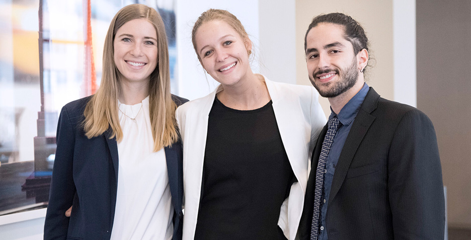 Three students in suits smiling Three students in suits smiling