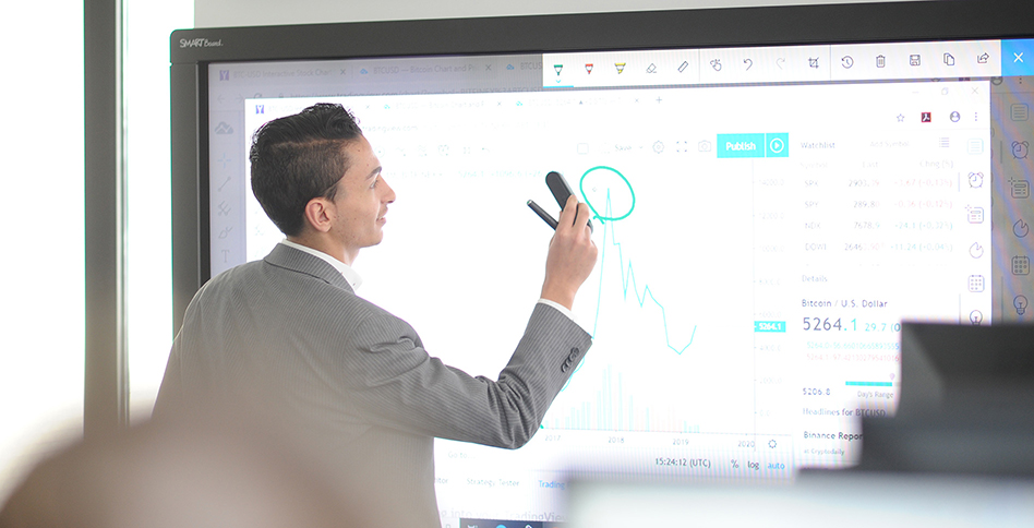 Businessperson showing graph on smartboard