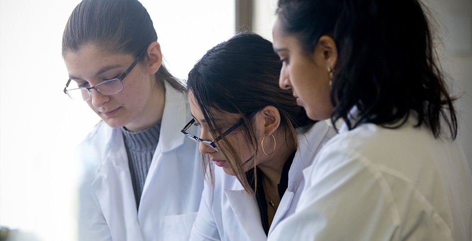 Three women in lab coats