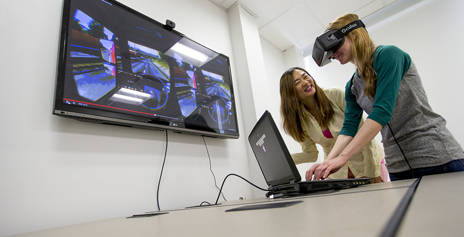 Student and faculty working with virtual reality simulator