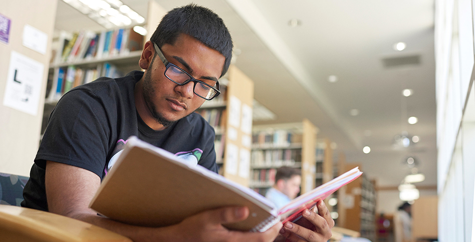 Student reading in library