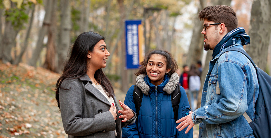 Three students talking outside on the Long Island campus