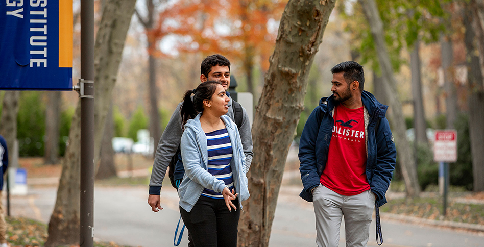 Three students walking down Long Island campus path
