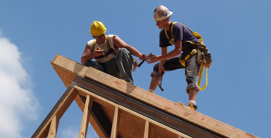 Two men working on roof structure