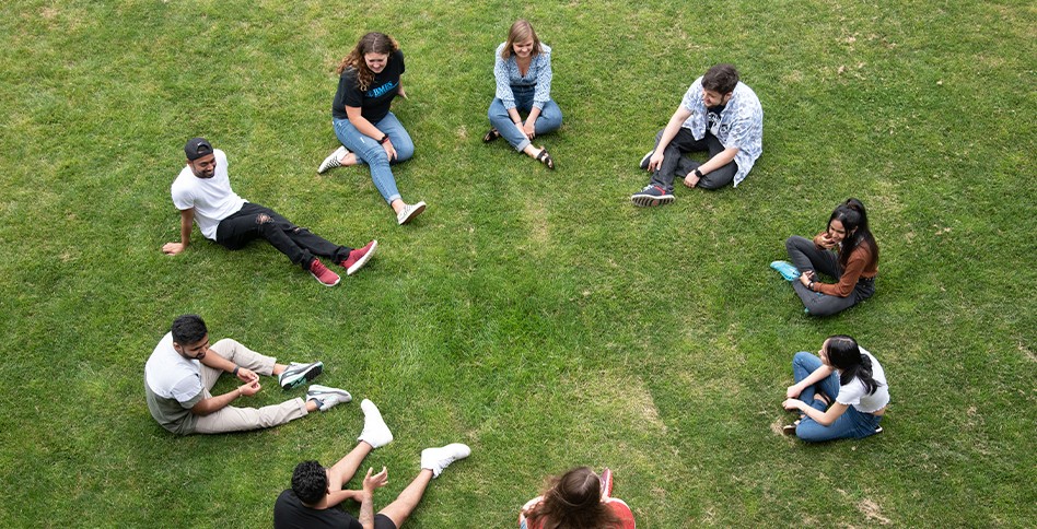Students sitting in circle in the grass