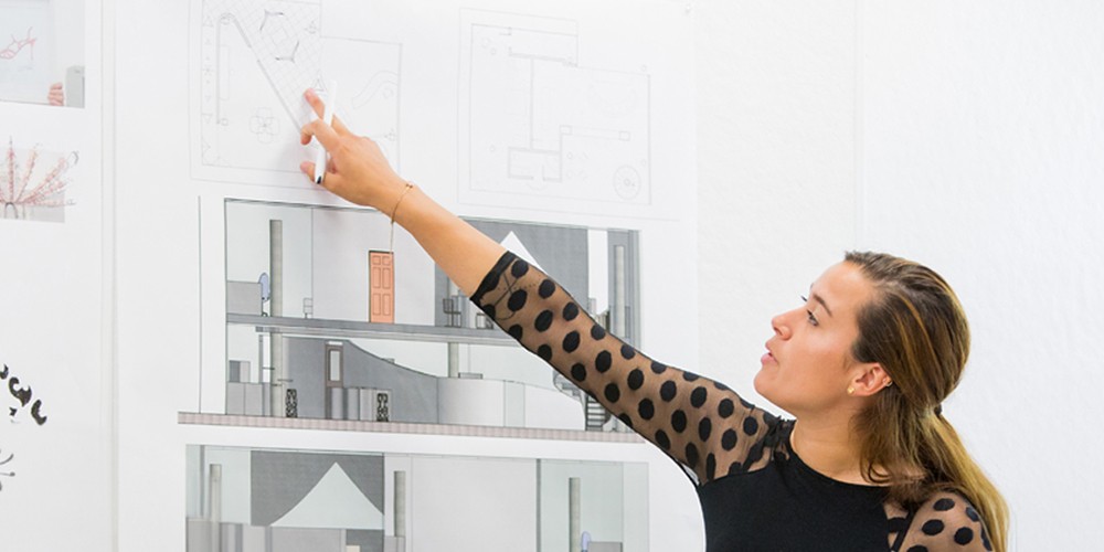 Student looking at architectural plans.