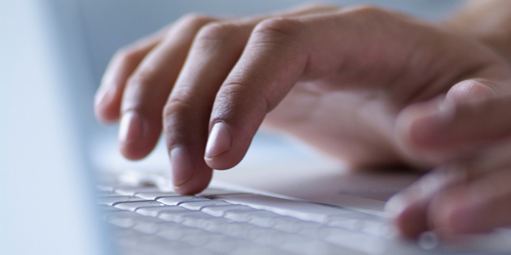 Hands typing on keyboard.
