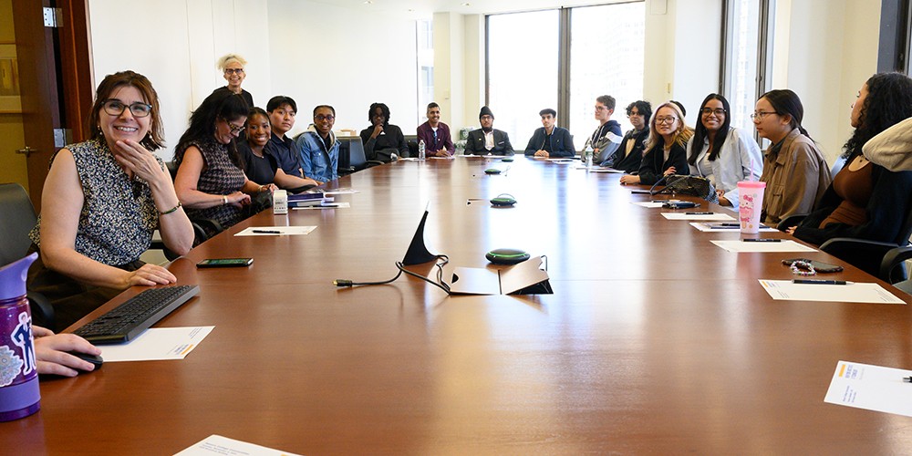 Many students around a conference table.