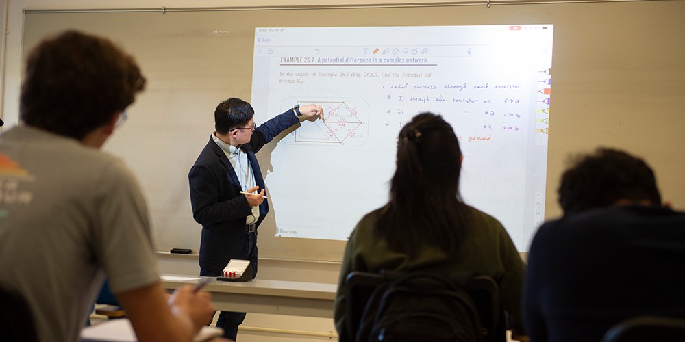 Faculty teaching at whiteboard