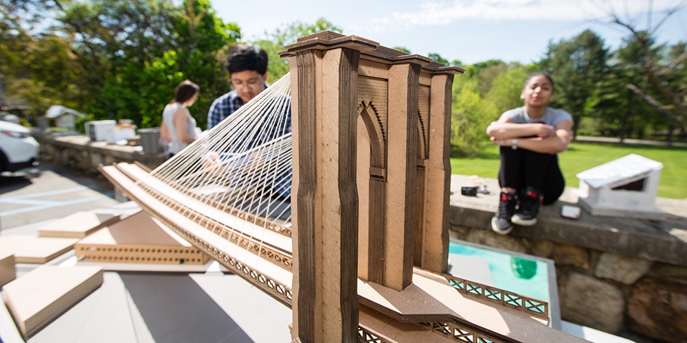 Students working with bridge model