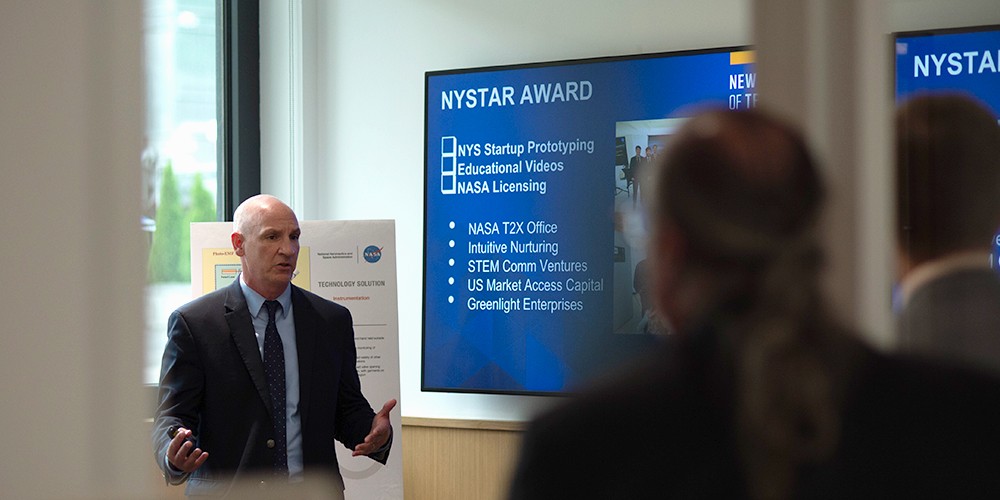 Man presenting at smart board