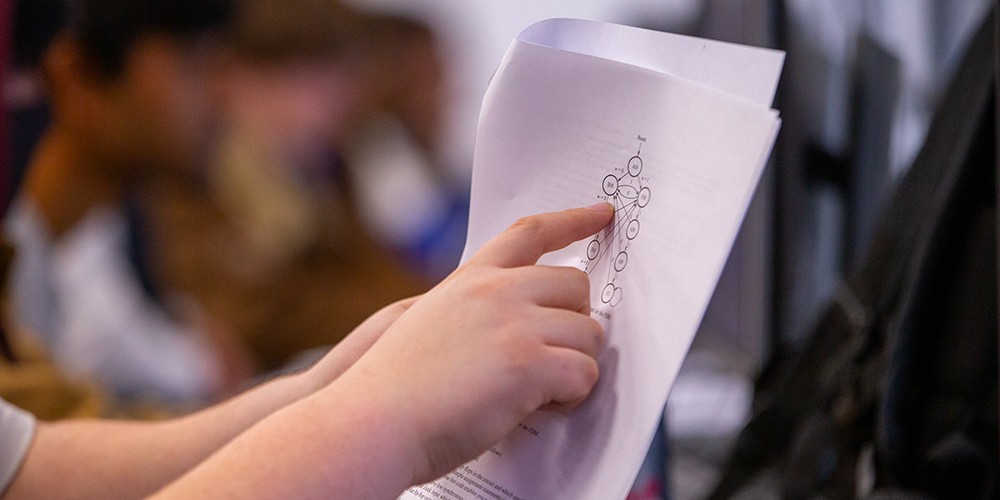 Hands pointing at diagram