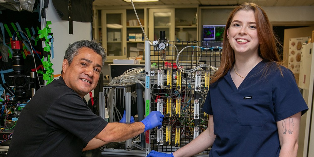 Researchers in front of testing equipment
