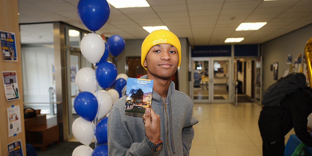Student holding up info card