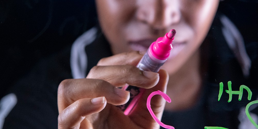 Hand holding dry erase marker