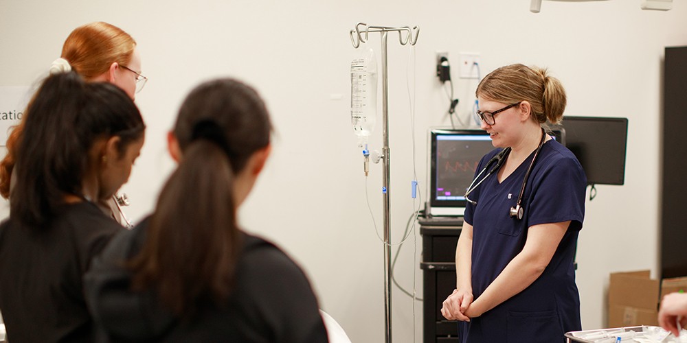 Nurses standing around IV
