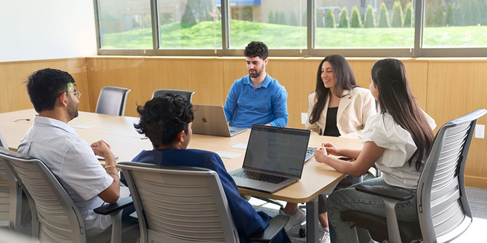 Many students around a conference table